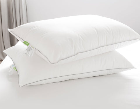 Pillow pair on bed showing scooms care label