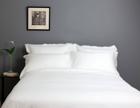 Made Bed with White Sheets In Scandinavian Bedroom | scooms