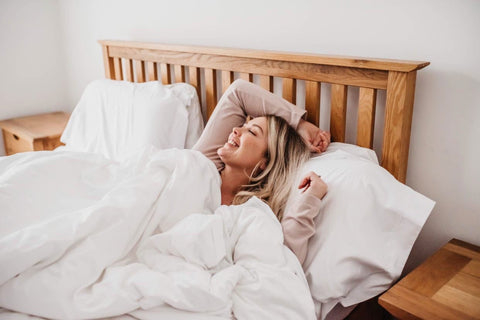 Woman in bed under duvet