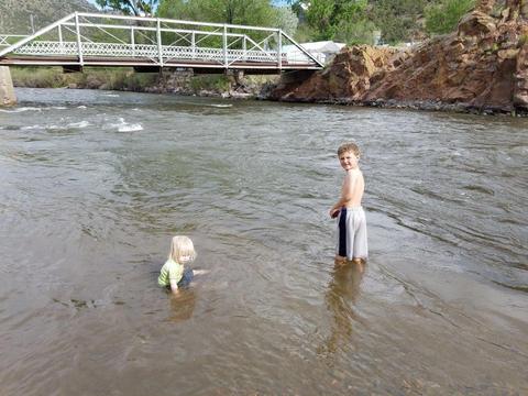 Granddaughter and grandson playing in the Arkansas River at Texas Creek