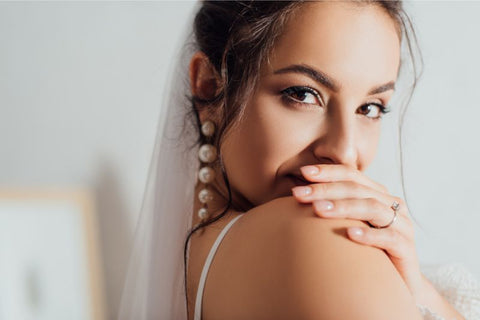 Bride with hair up and elaborate earrings