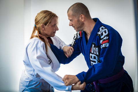 man and woman engaging in jui jitsu