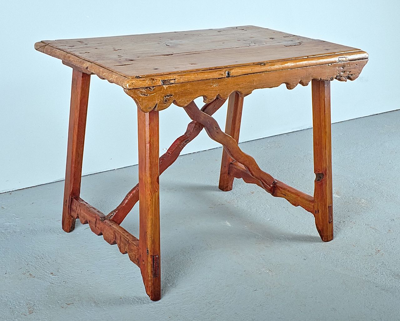Antique trestle leg scalloped skirt table with wooden stretchers, pine