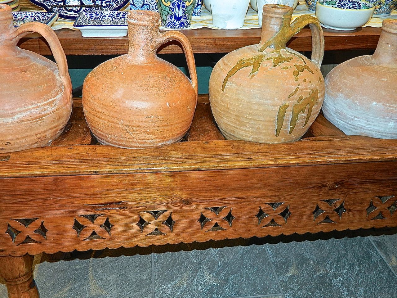 Antique five-hole pierced water jug stand with original clay jugs, pine