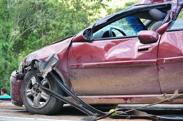 Red car that has recently been in a car accident