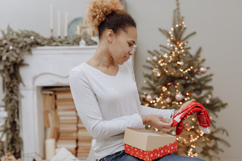 woman opening wrapped socks as a gift