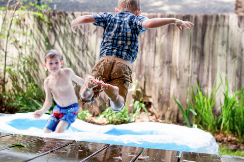 kid jumping into pool