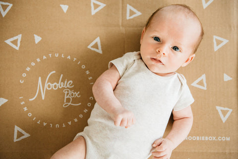 newborn baby looking up at camera