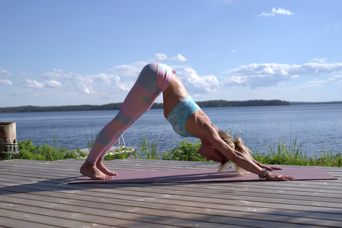 woman in downward facing dog pose