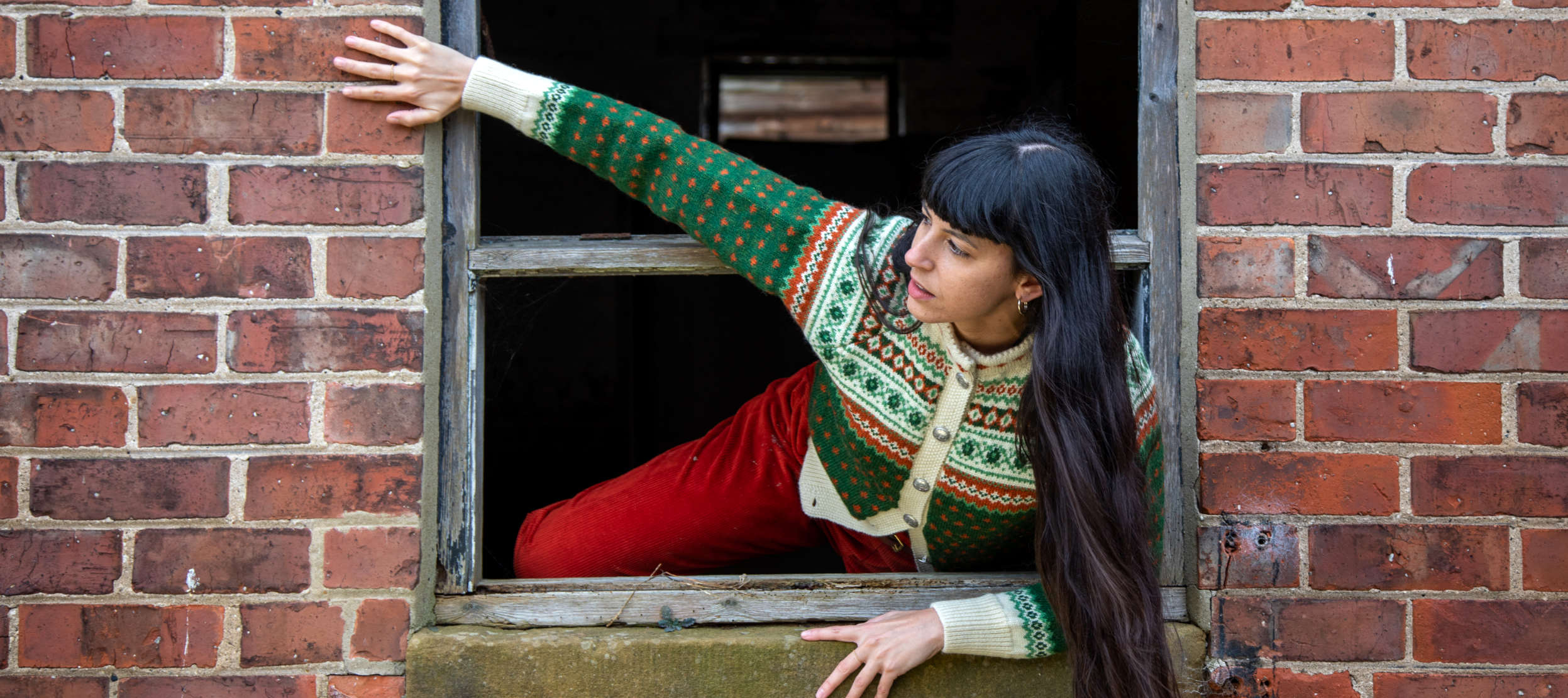 Woman wearing a green knitted wool cardigan