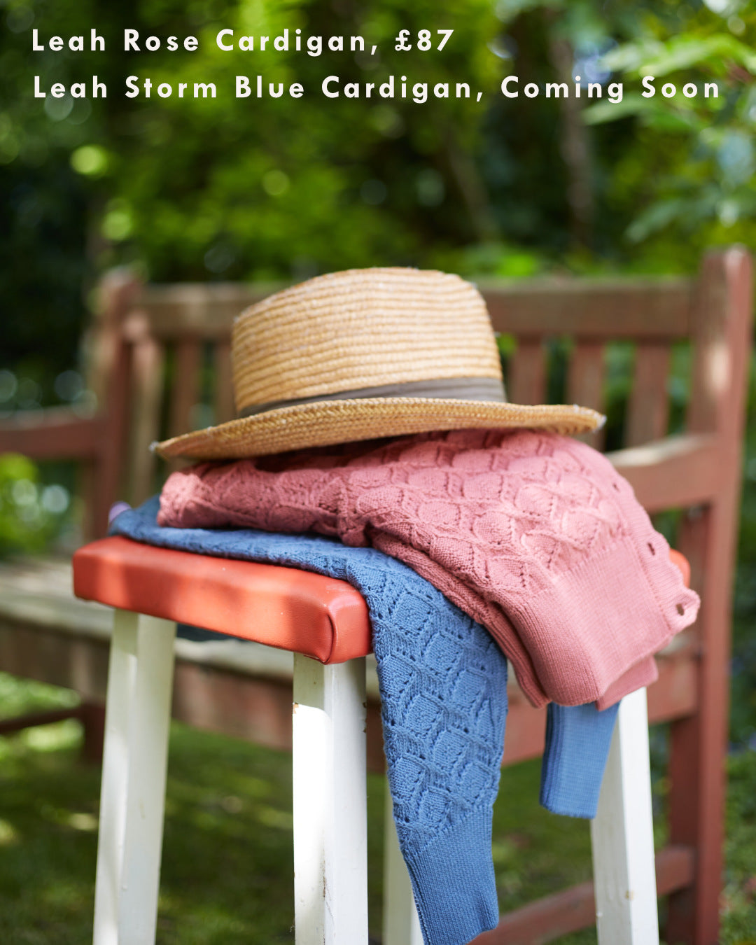 Folded pink and blue knitwear on a stool. 