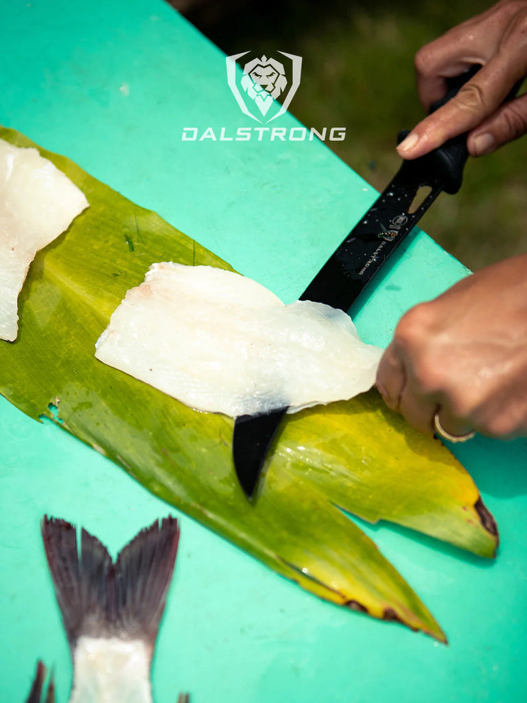 A photo of a hand filleting a fish using the Butcher Knife 10" Night Shark Series | NSF Certified | Dalstrong