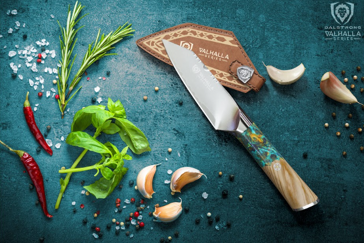 A photo of the Paring Knife 4" Valhalla Series Dalstrong with the sheath, spices and herbs beside it.