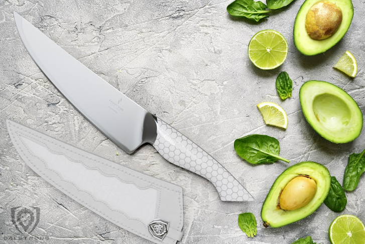 A photo of the Chef's Knife 8" Frost Fire Series | NSF Certified Dalstrong with sheath and sliced avocado beside it.