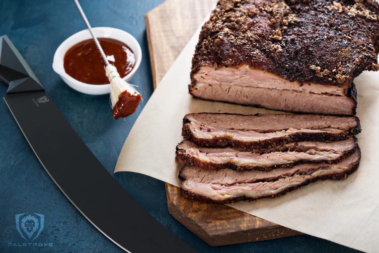 Dalstrong Butcher & Breaking Knife beside sliced brisket