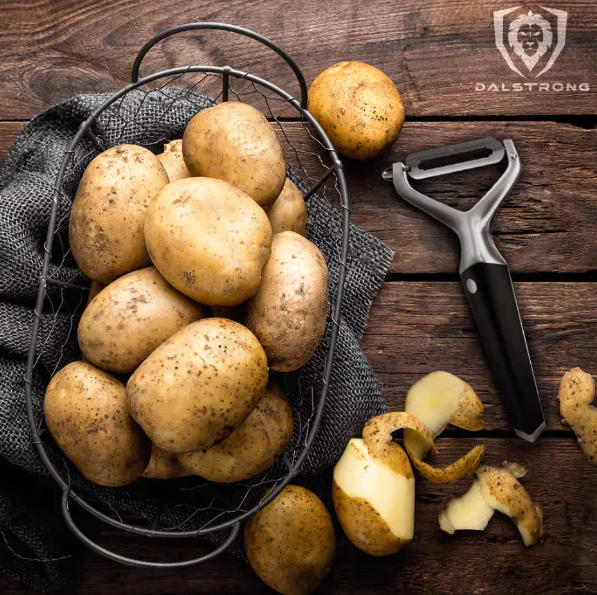 A photo of the Y Peeler 3 Blades Case | Dalstrong with bunch of potatoes.