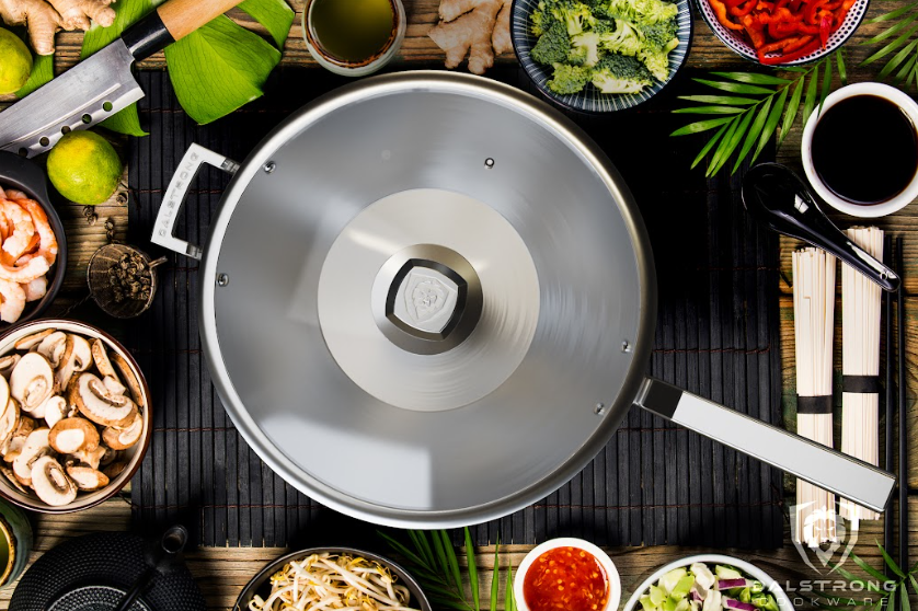 A photo of the 12" Frying Pan Wok Silver | Oberon Series | Dalstrong in the middle of different kinds of vegetables