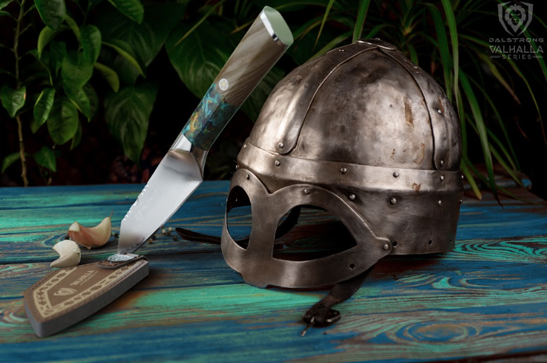 A photo of the Paring Knife 4" Valhalla Series | Dalstrong with a viking helmet beside it.