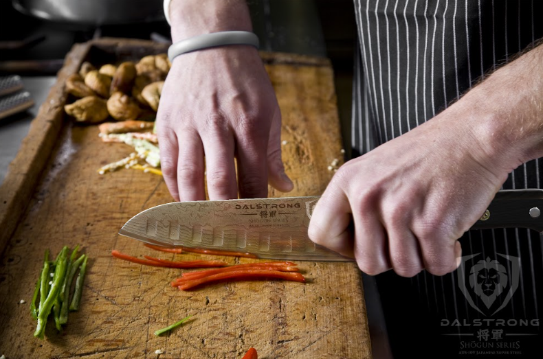 A photo of a hand slicing red bell pepper using the Santoku Knife 7" Shogun Series ELITE | Dalstrong