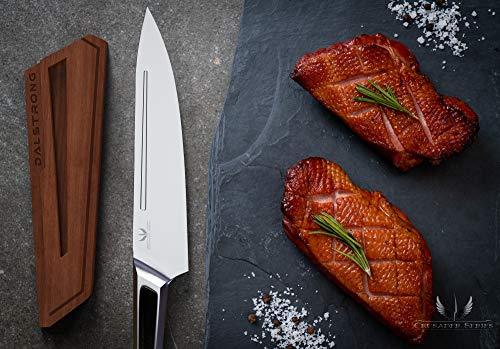 Chef knife with stainless stell handle next to some uncooked meat