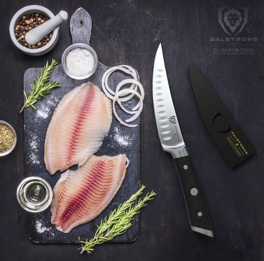 A photo of the Curved Fillet Knife 6" | Gladiator Series | NSF Certified | Dalstrong with two fillet of fish on top of a wooden board