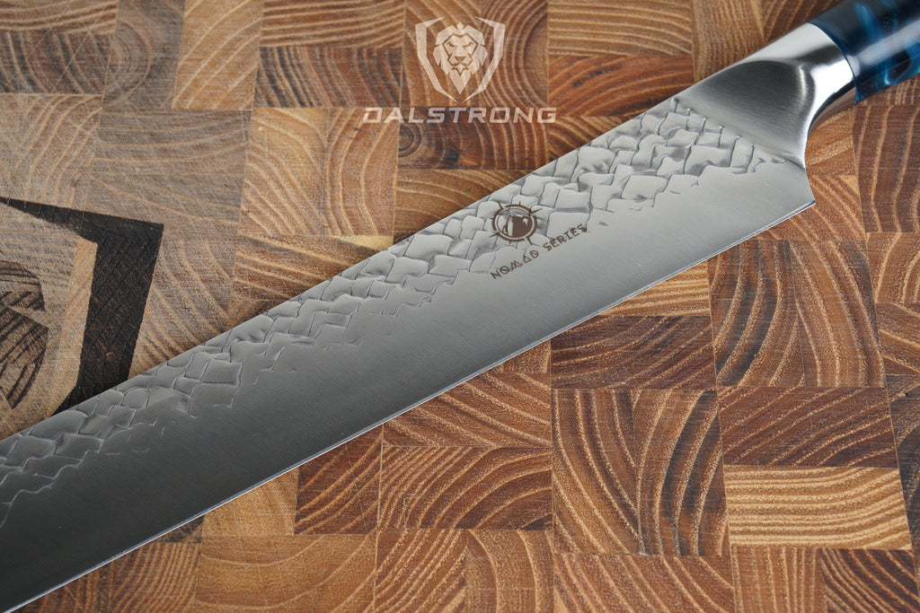 The Cooking Guild Nomad Slicing knife on a Dalstrong wooden cutting board