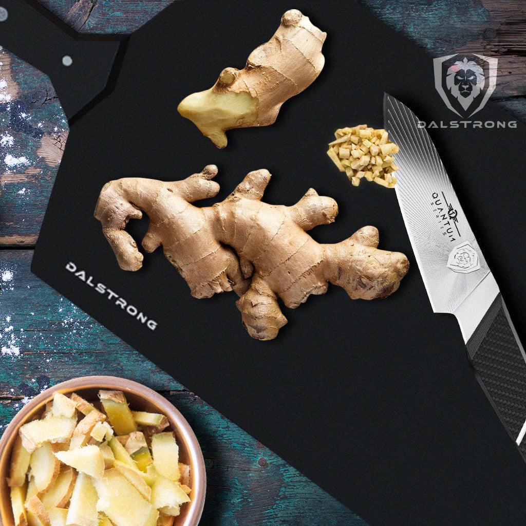 omega series paring knife on cutting board with ginger root