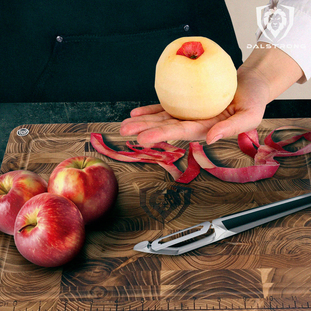 Swivel Peeler cutting red apples on top of cutting board