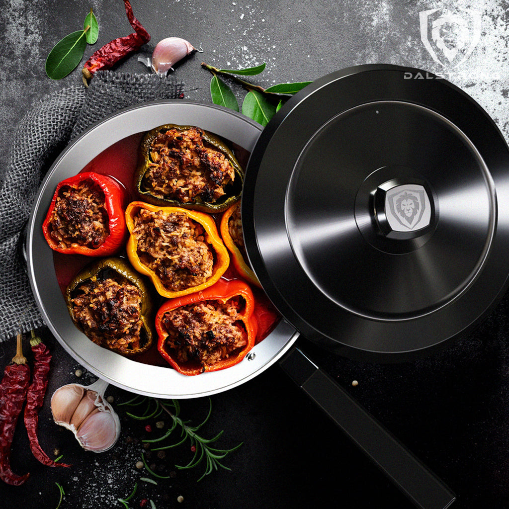 A black frying pan containing six stuffed peppers