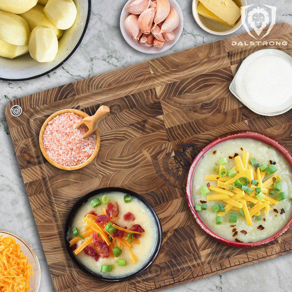 loaded baked potato soup on teak cutting board