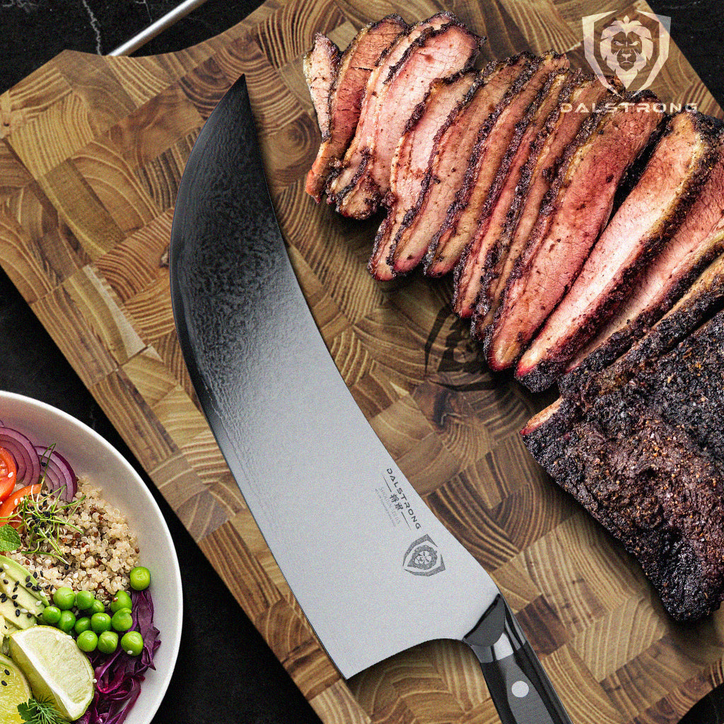 Dalstrong meat cleaver on cutting board next to cooked brisket