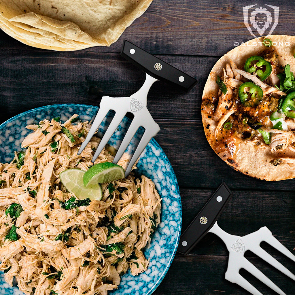 Meat shredding claws beside a plate of pulled chicken and a small tortilla 