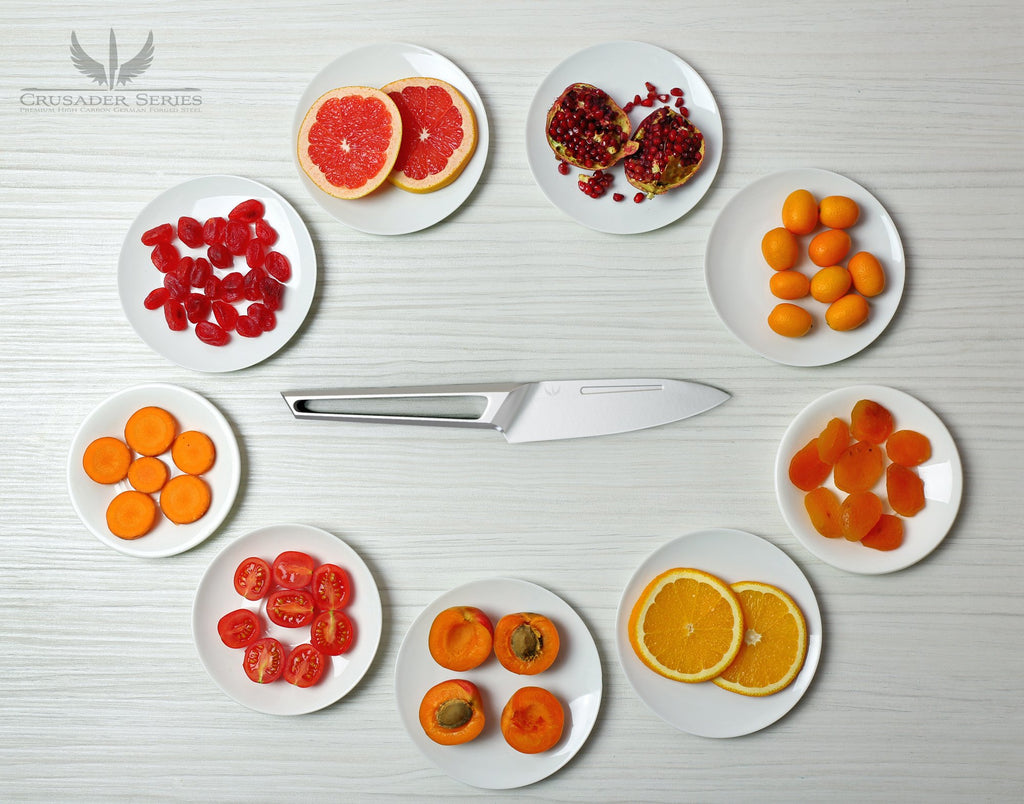Stainless steel paring knife with hollow handle surrounded by small plates of chopped fruit and vegetables 