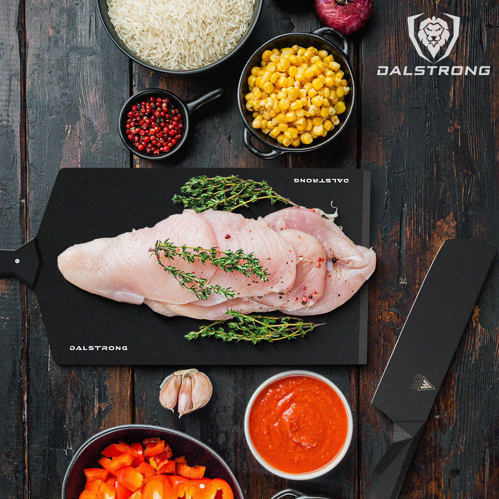 Chicken Enchilada ingredients laid out on a wooden table with Dalstrong Shadow Black Series knife and cutting board