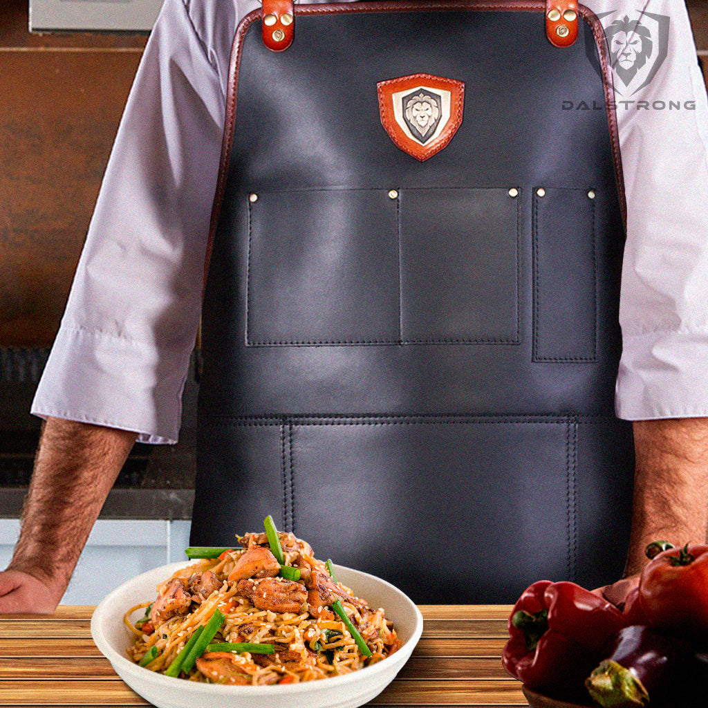 chicken lo mein in bowl in front of chef with apron