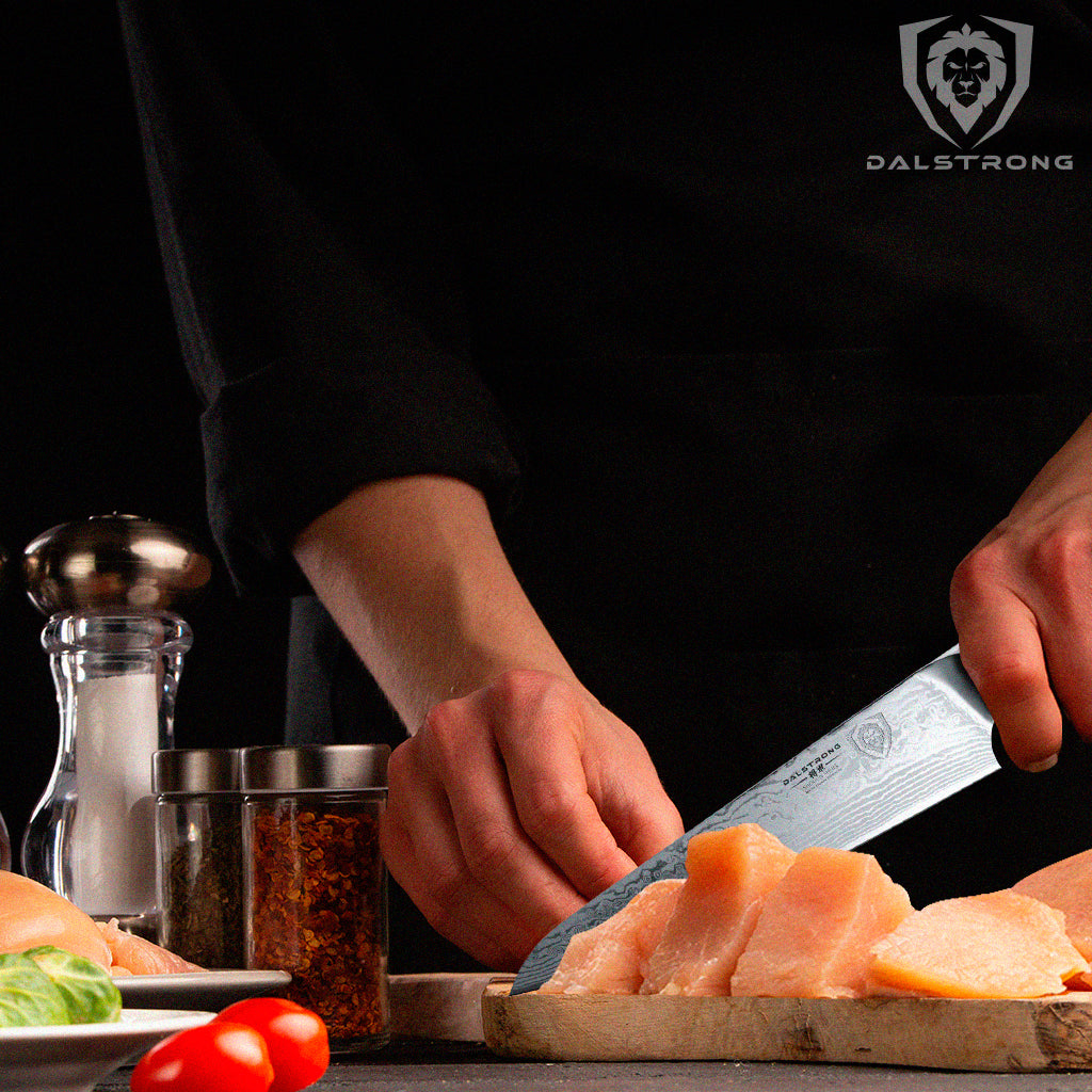 Chef Knife slicing chicken on cutting board