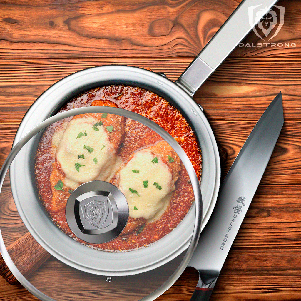 Chicken Parmesan in a Dalstrong skillet frying pan with a knife beside it.