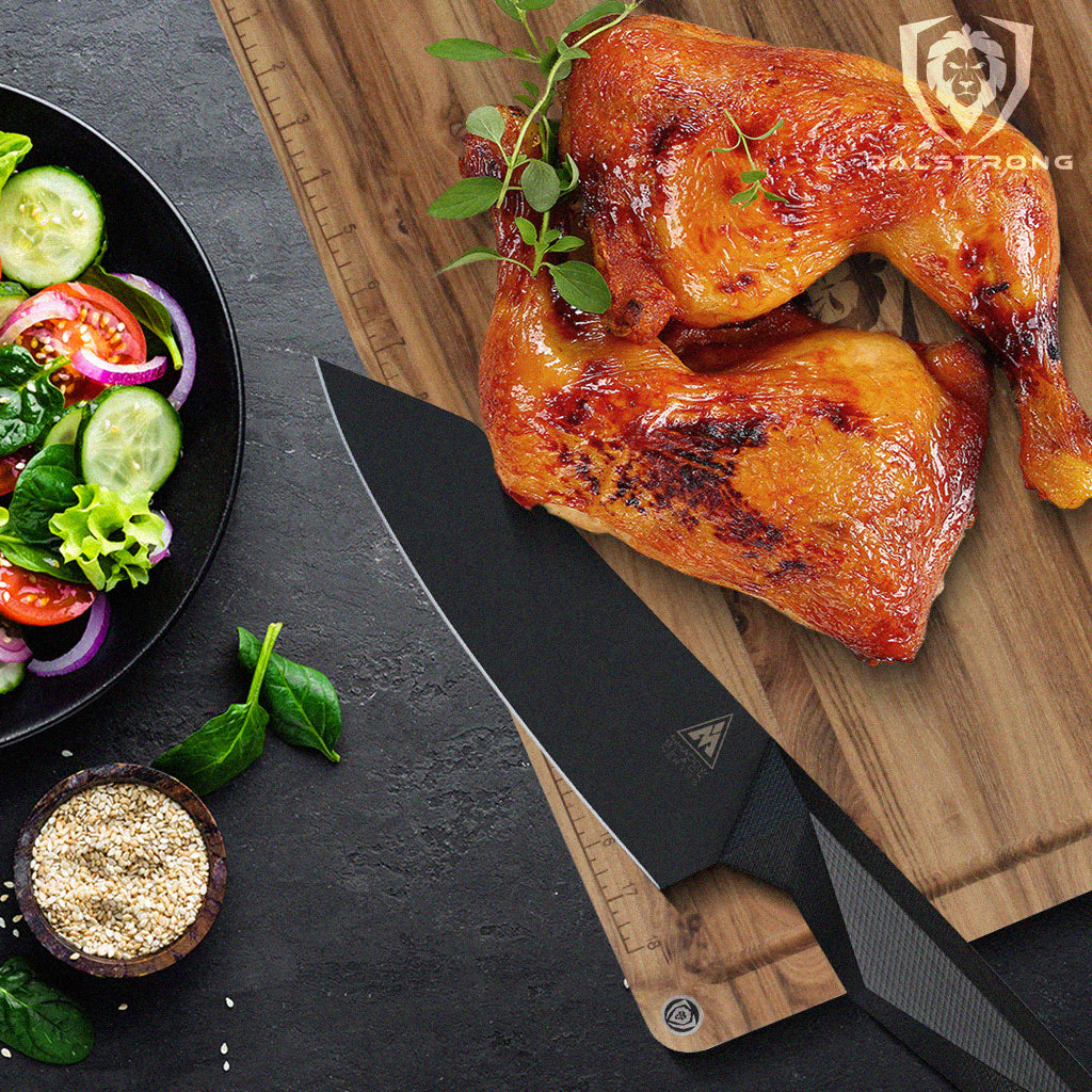 chef knife laying on cutting board beside seasoned chicken thighs