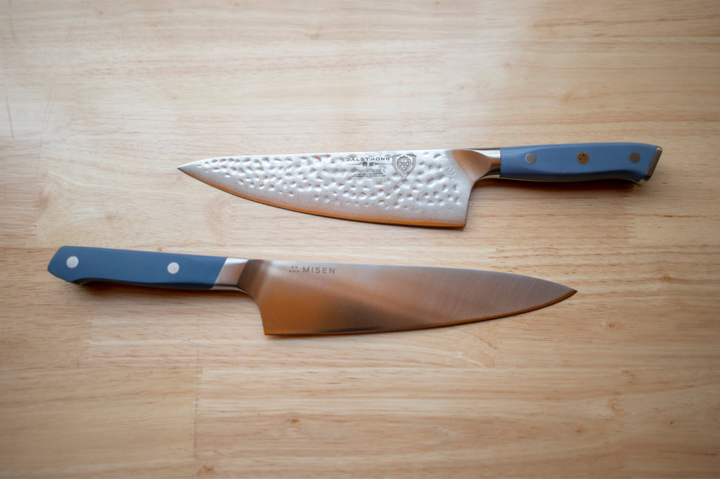 misen knife laying beside Dalstrong knife