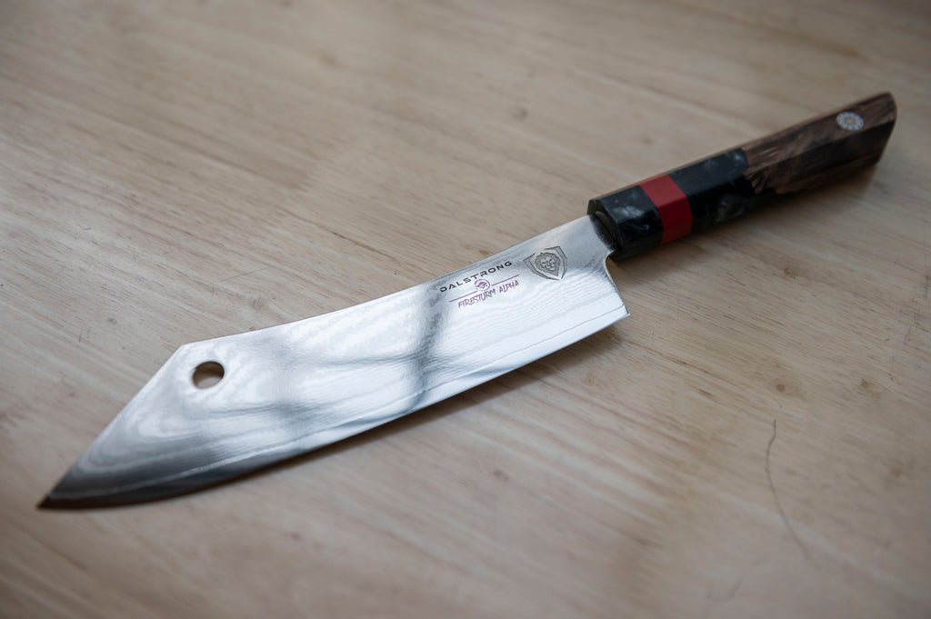 A close-up shot of the Dalstrong Firestorm Alpha Series 8" Chef & Cleaver Hybrid knife on a wooden surface.