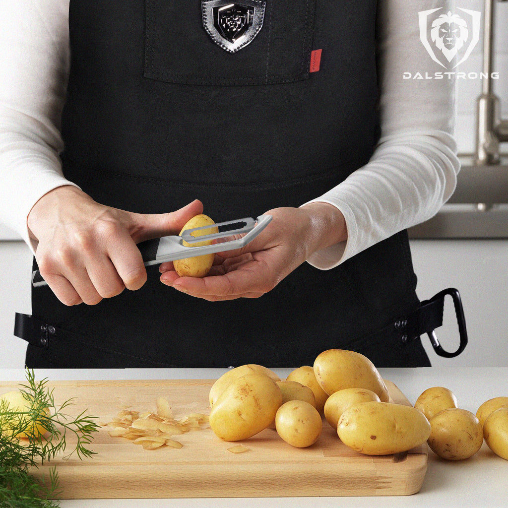 swivel peeler being used by chef to peel potatoes