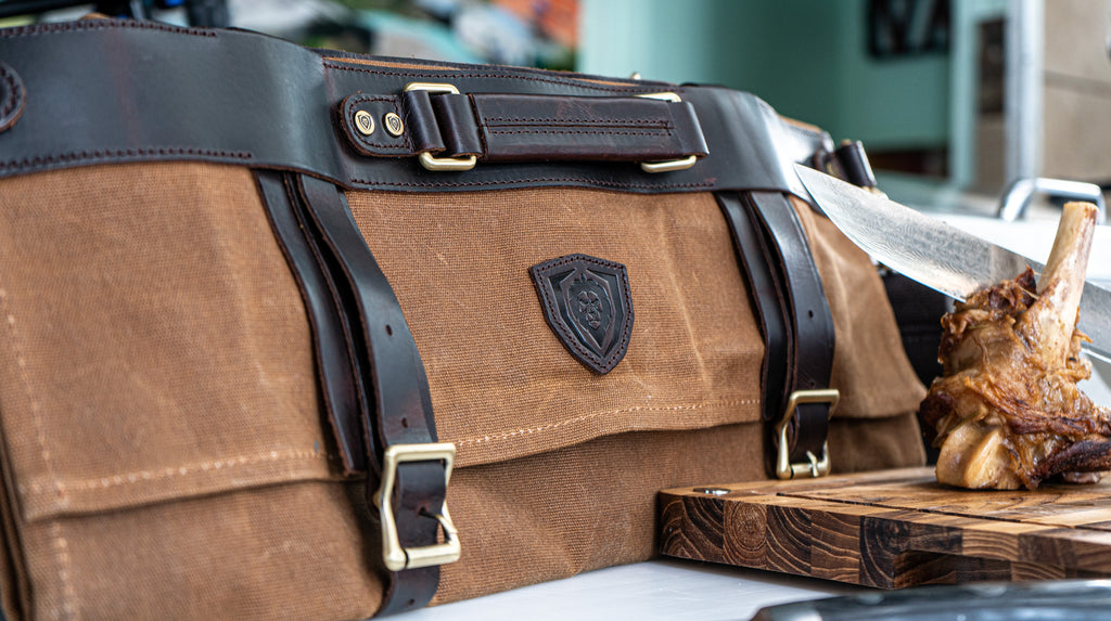 nomad xl knife bag in front of braised lamb shank on cutting board