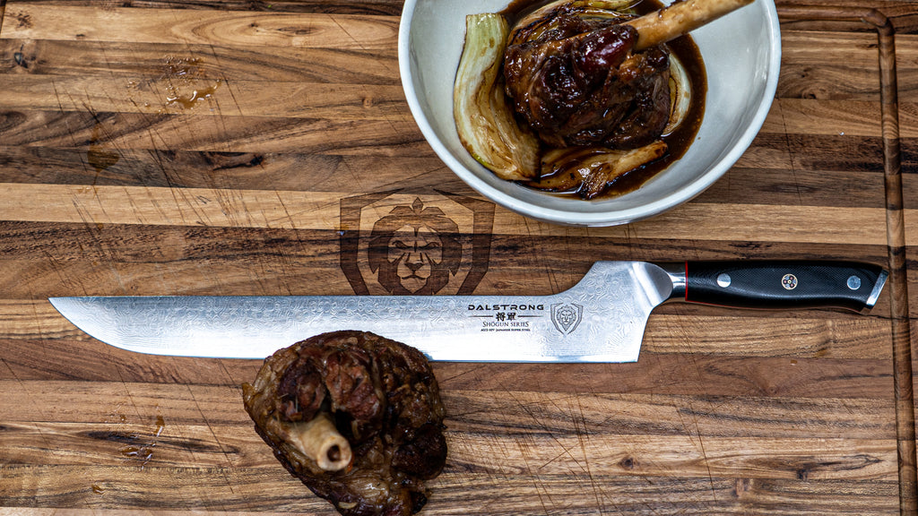 braised lamb shank on cutting board with offset knife