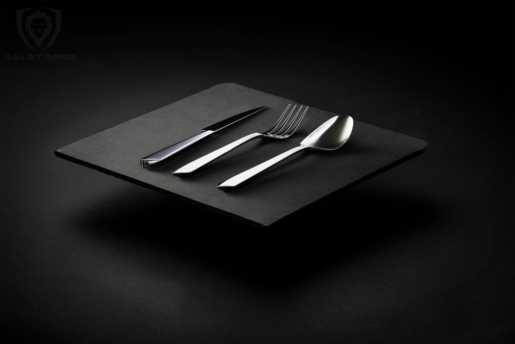 A cinematic photography of the Dalstrong Flatware Set in an all-black background.