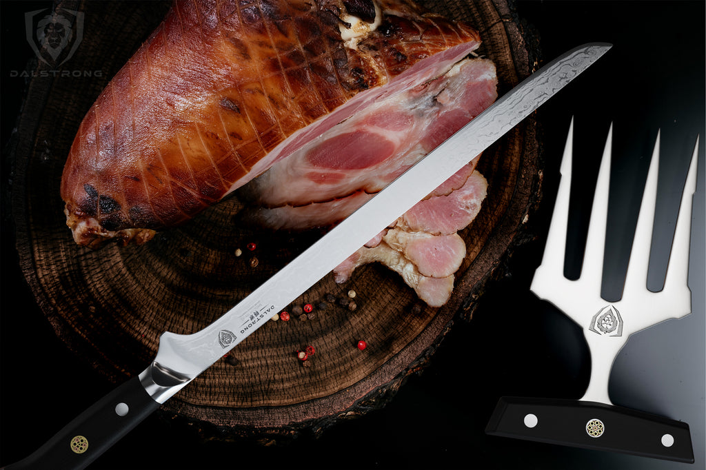 A large cooked ham next to a boning knife next to meat shredding claws 