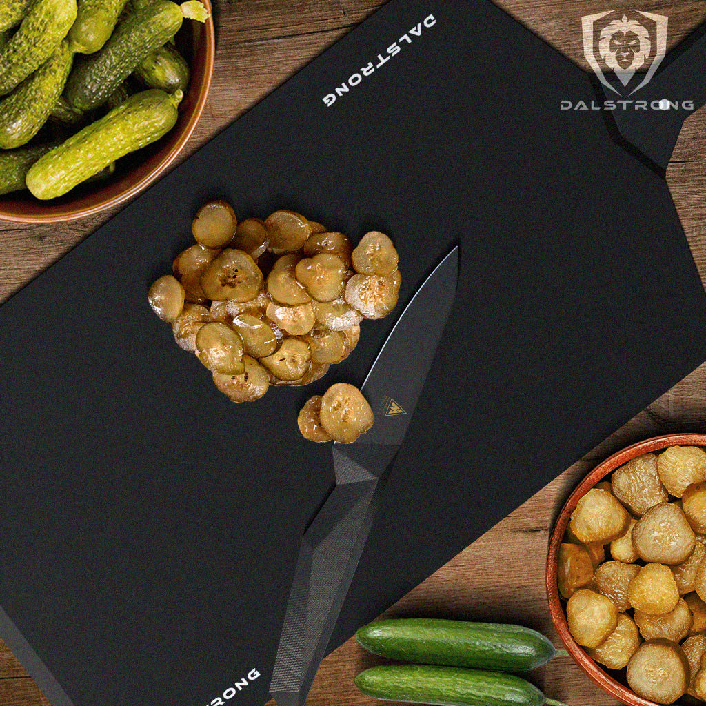 paring knife on cutting board beside sliced dill pickles