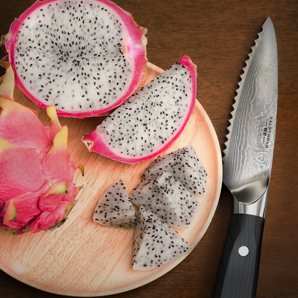 A chopped dragon fruit on a circular cutting board next to a serrated paring knife