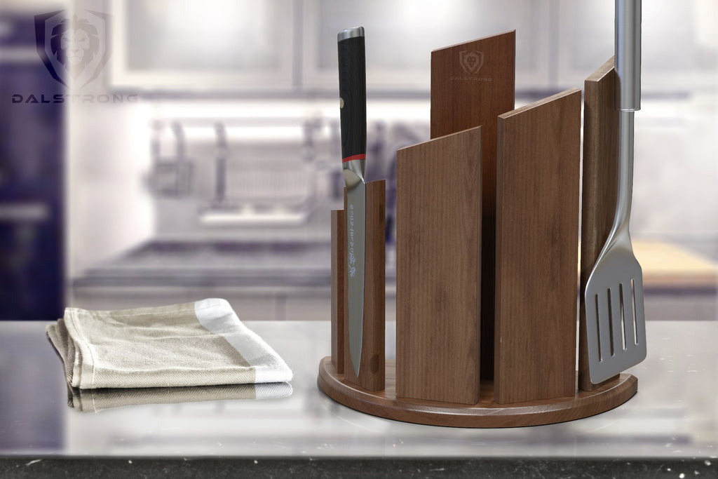 Dalstrong Wooden Magnetic Knife Block on a huge countertop with a knife and spatula attached to it.