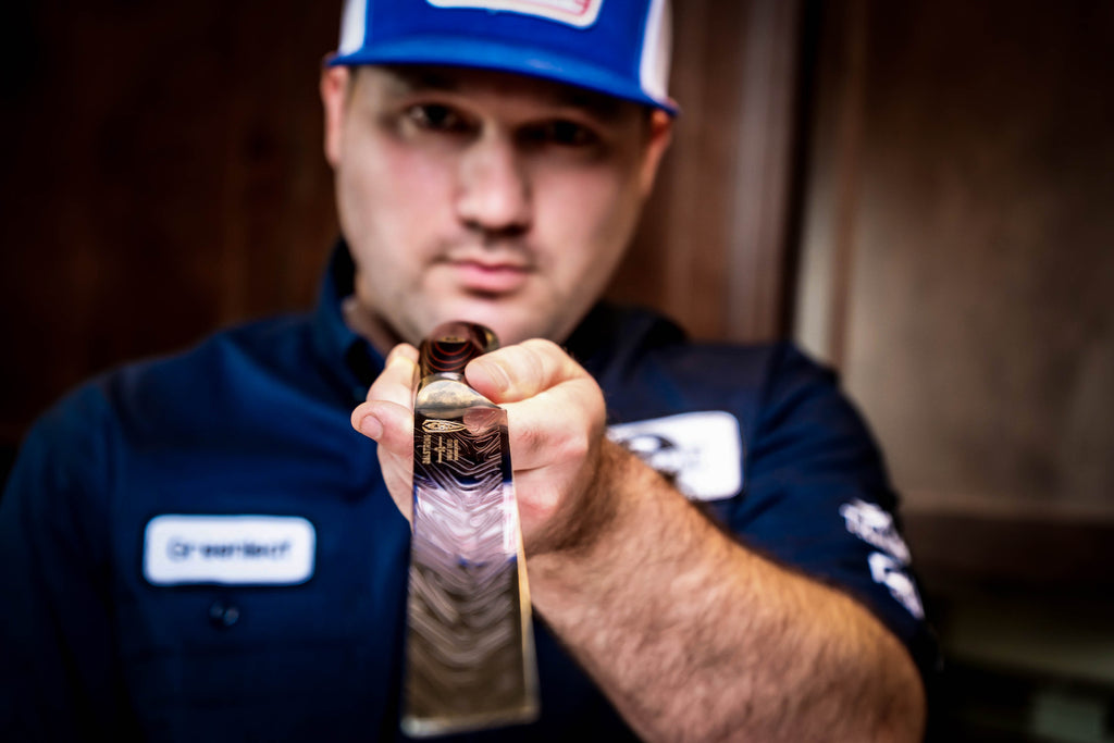 James Greenleaf (@greenleaf.bbq) pointing a slicing and carving knife toward the camera