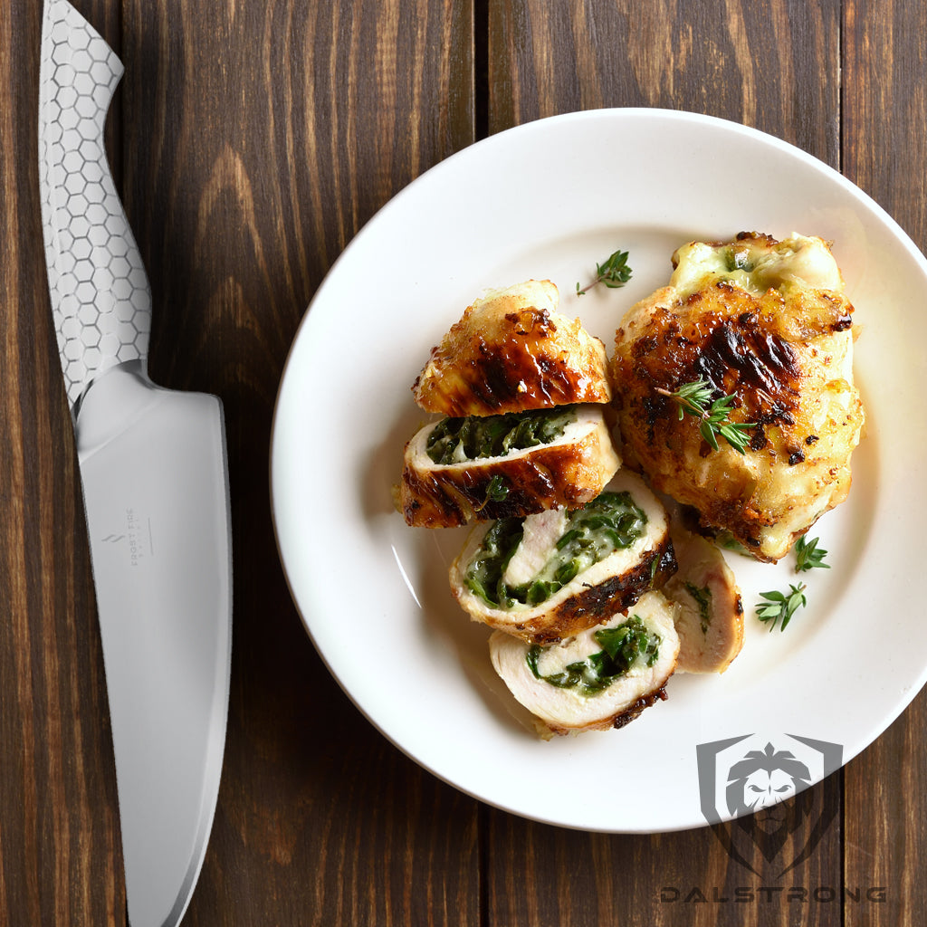 stuffed chicken breast on plate beside chef knife